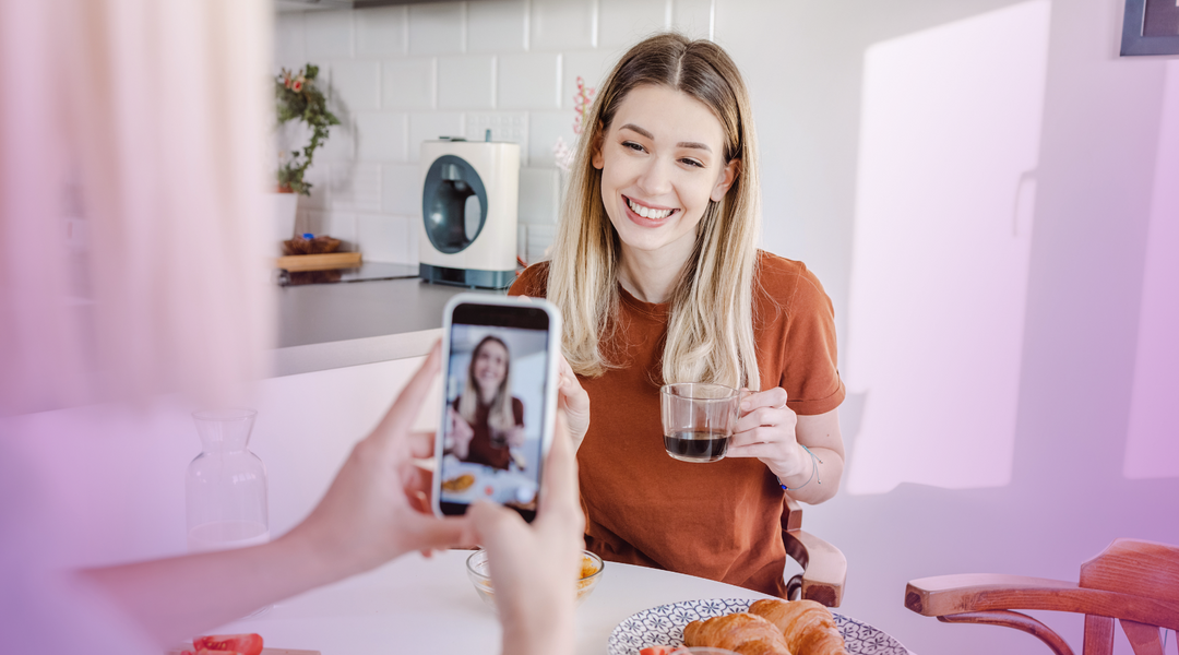 A women making content using her phone, a representation for the emerging content marketing.